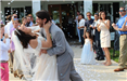 Groom Dips Bride in Bubble Celebration