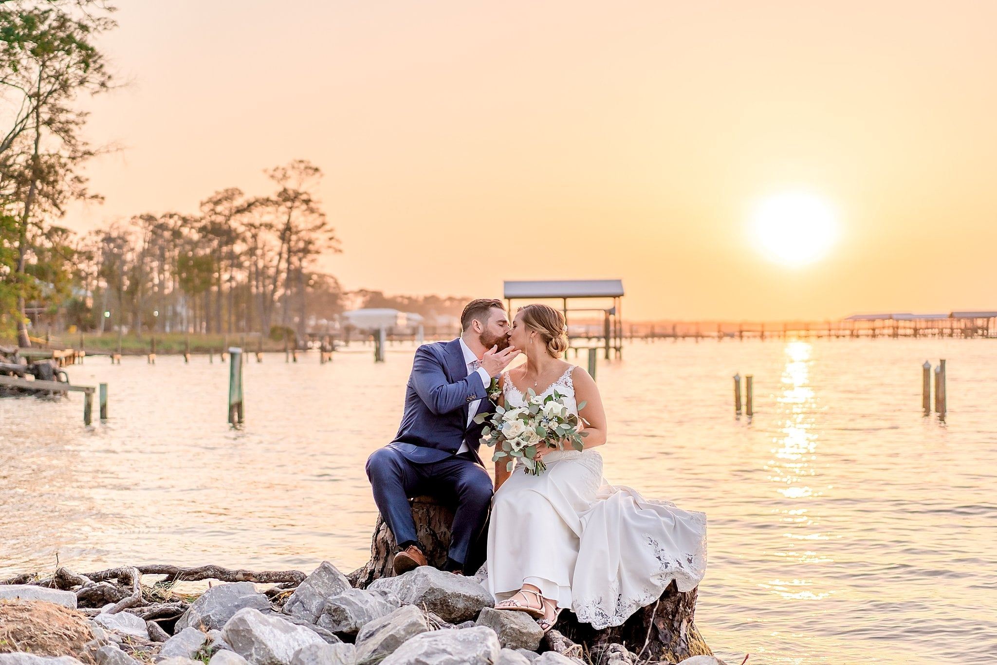 Couple kissing in front of Wolf Bay.