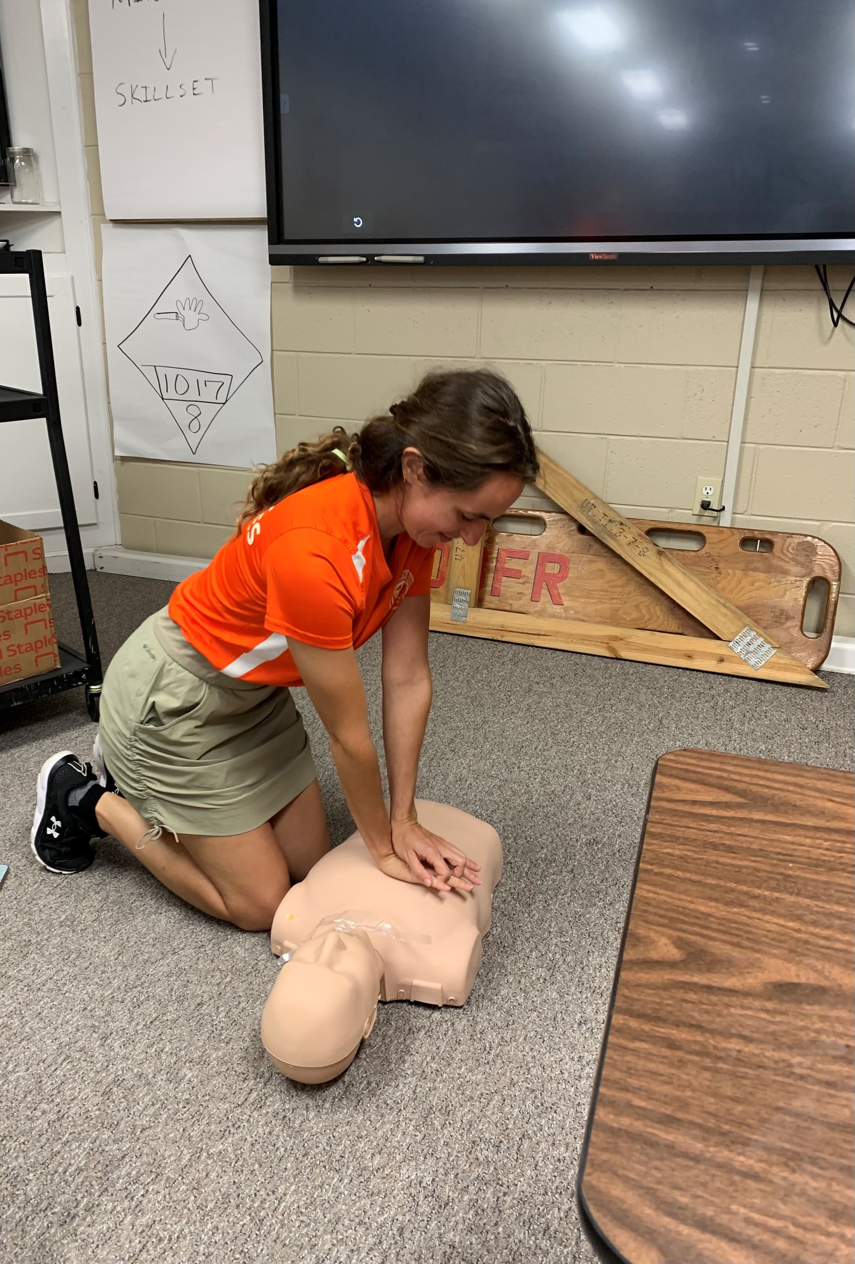 Coastal Resources employee is performing chest compressions on CPR dummy
