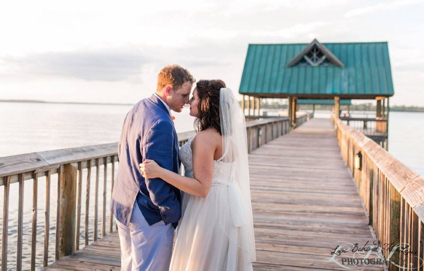 Bride and Groom Embrace on Dock