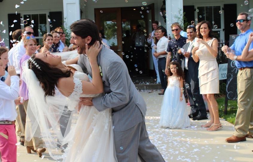 Groom Dips Bride in Bubble Celebration
