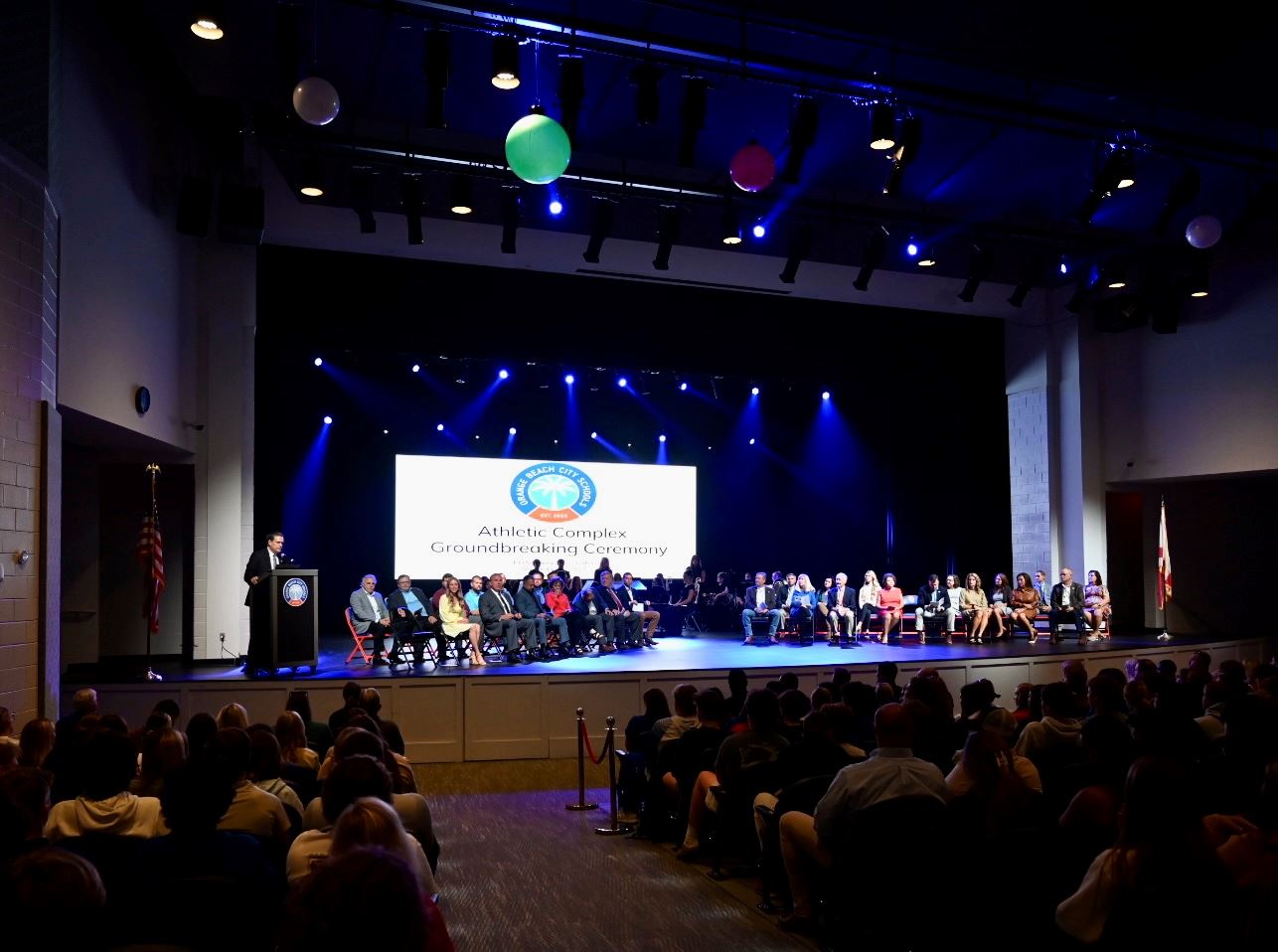 Stage full of people and full audience at the Orange Beach Performing Arts Center